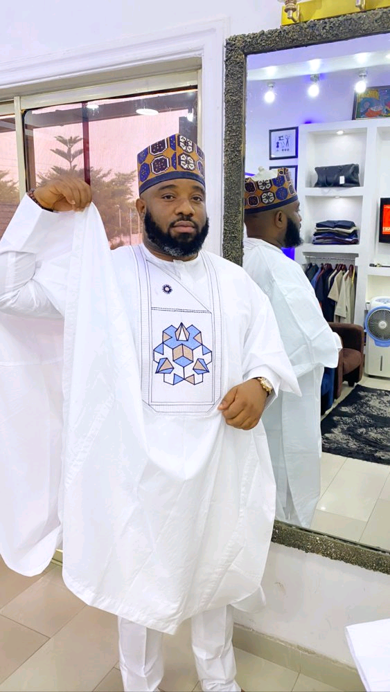Full view of white three-piece Agbada set with blue and gold geometric embroidery