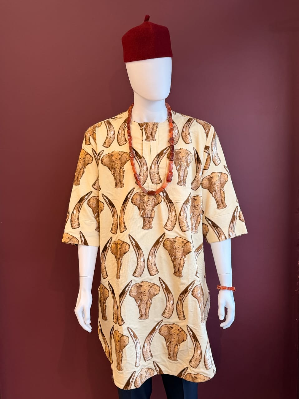 Cream elephant and horn print Isiagu shirt for men in an African-inspired traditional design