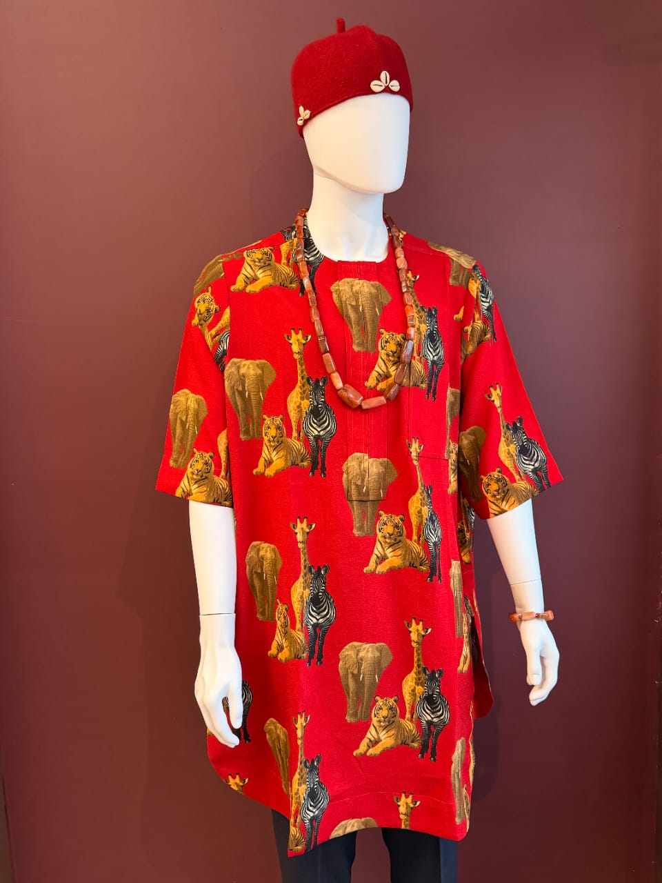 Red African animal print Isiagu shirt for men featuring elephant, tiger, zebra and giraffe patterns