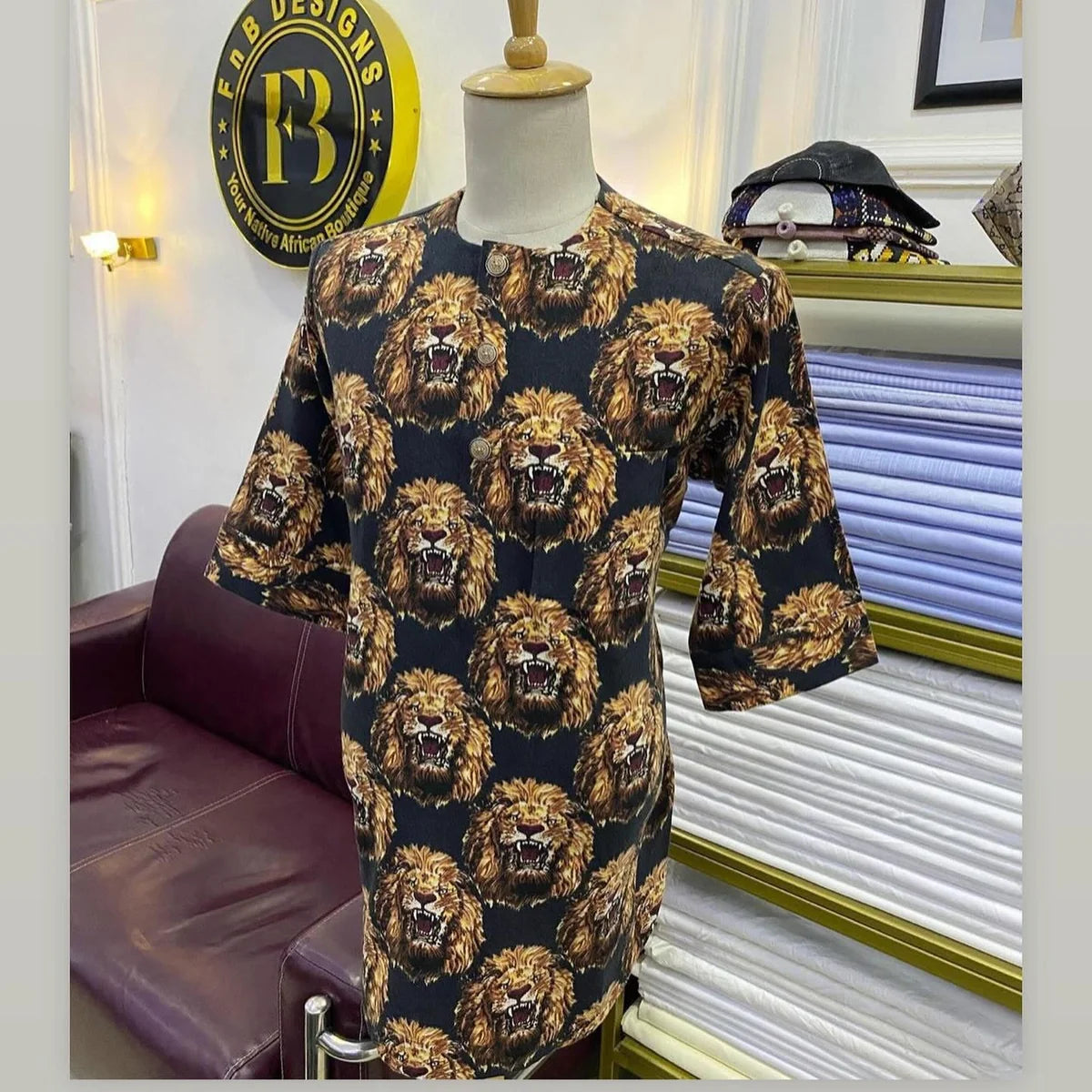 Men’s cream Isiagu with repeating brown and black lion-head print